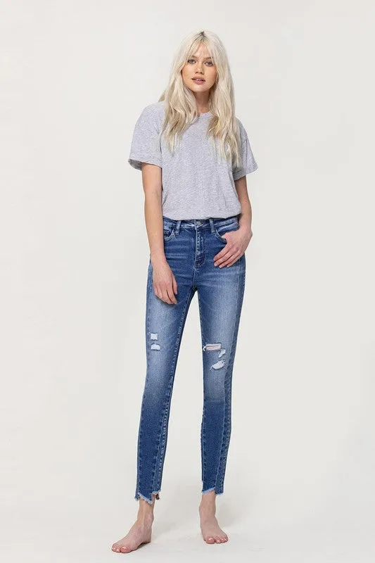 HIGH RISE ANKLE SKINNY W UNEVEN HEM DETAIL